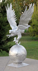 large flying eagle statue on ball with fish