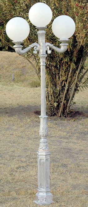 early American lamp post with 3 lights