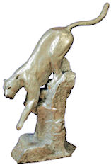 cast aluminum statue of a couger climbing down a cliff