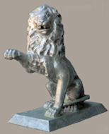 cast aluminum lion statue with paw raised