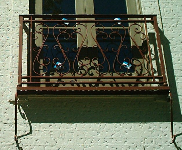 wrought iron false balcony with scroll design railing